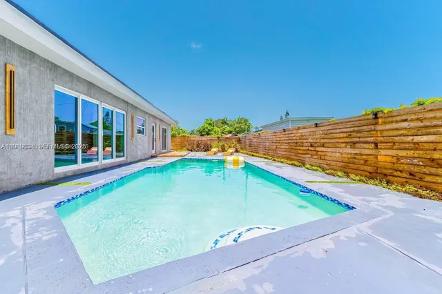 a view of a swimming pool with a patio