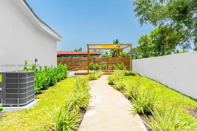 an aerial view of a house with a garden and swimming pool