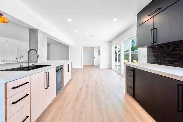 a kitchen with stainless steel appliances a refrigerator sink and cabinets