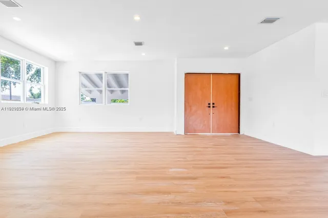 a spacious bedroom with a large bed and a window