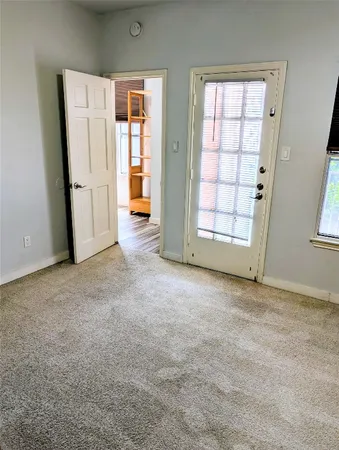 wooden floor in an empty room with a chandelier fan