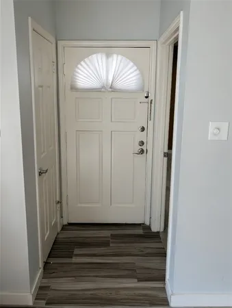 a view of a entryway door with wooden floor