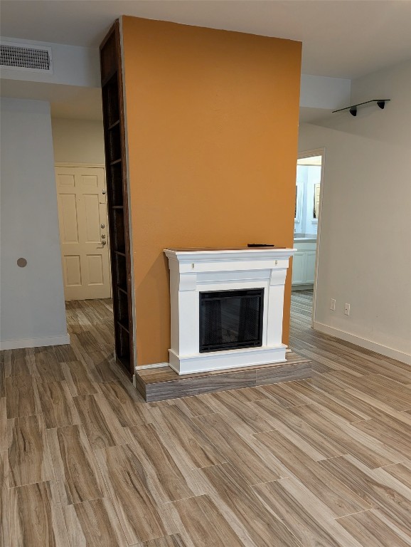 2529 Rio Grande Street, Unit 6 Austin, TX 78705 - Photo 3 of 19 a view of an empty room with wooden floor and a fireplace