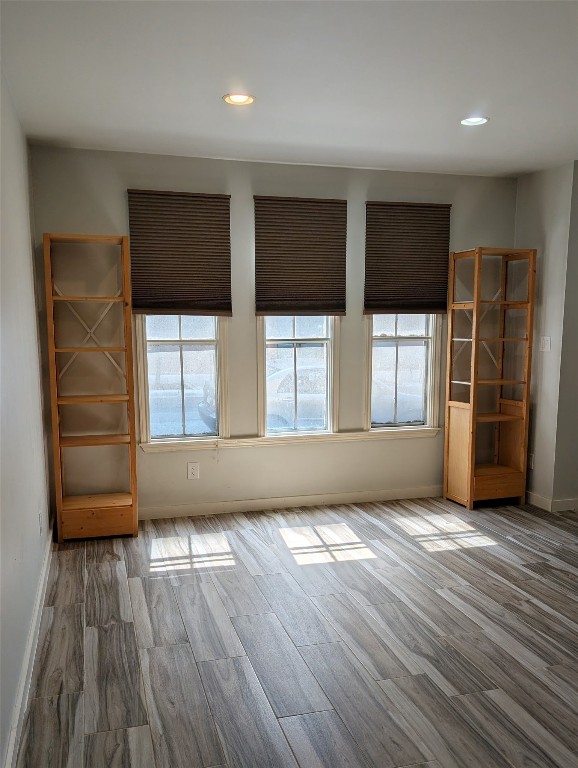 2529 Rio Grande Street, Unit 6 Austin, TX 78705 - Photo 4 of 19 an empty room with wooden floor and windows