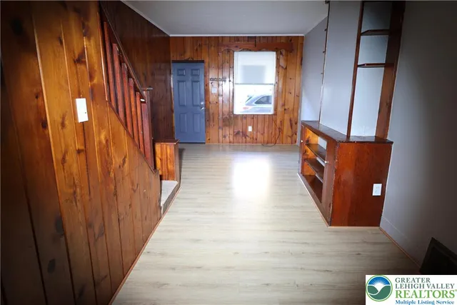 a view of hallway with wooden floor