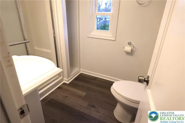 a white toilet sitting next to a bathroom sink