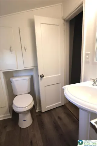 a white toilet sitting next to a bathroom sink