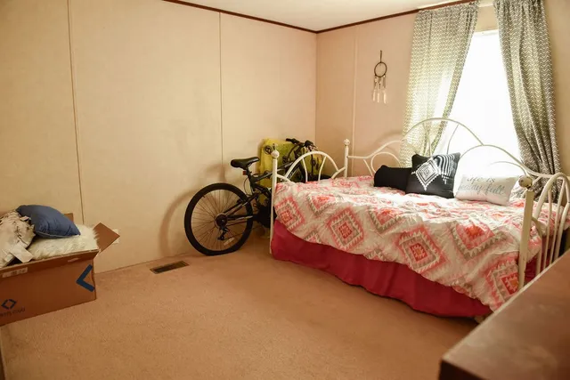 a bedroom with bed and a window