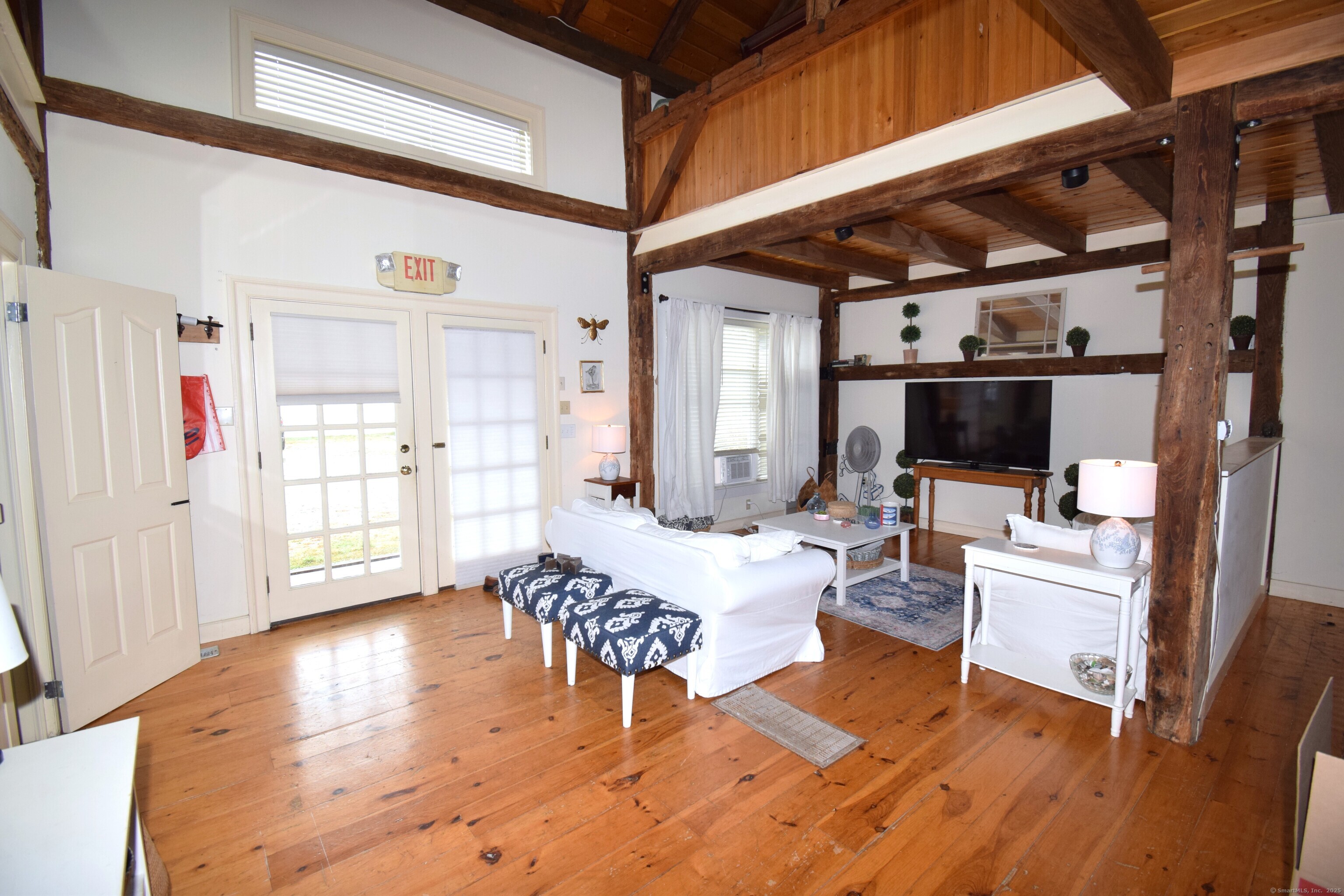 1306 Boston Post Road Westbrook, CT 06498 - Photo 5 of 12 a living room with furniture a wooden floor and next to a window