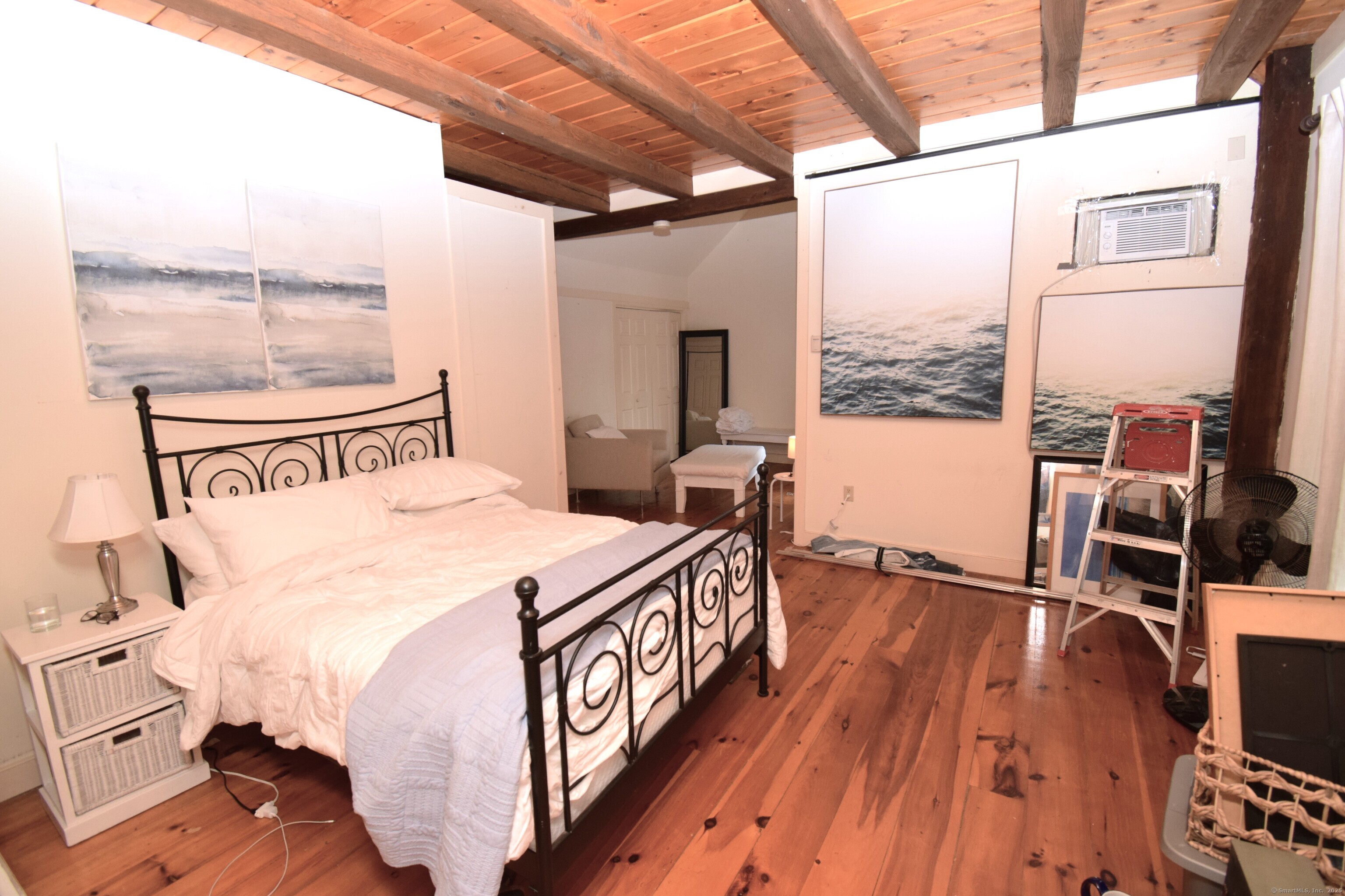 1306 Boston Post Road Westbrook, CT 06498 - Photo 6 of 12 a bedroom with a bed and a large window