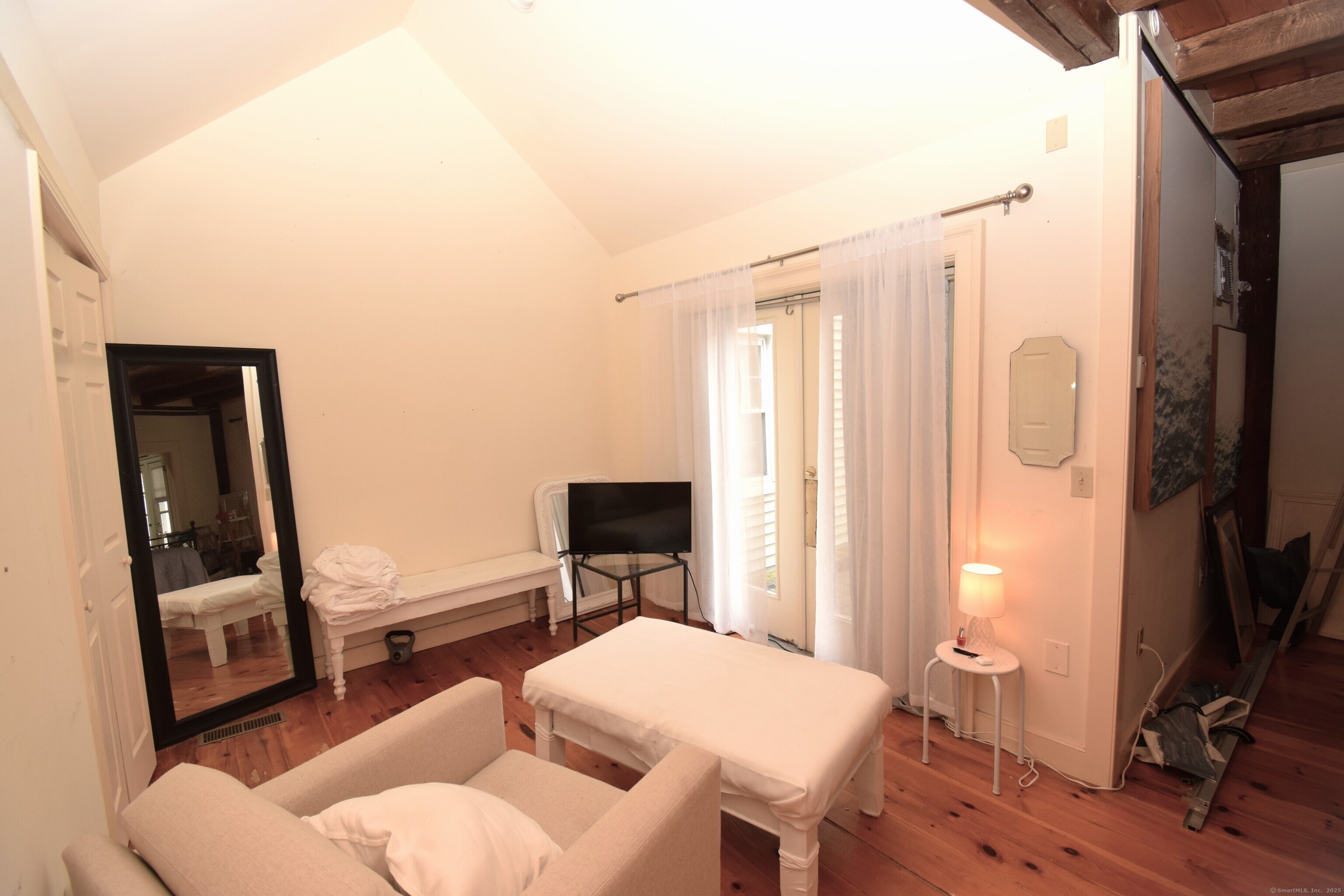 1306 Boston Post Road Westbrook, CT 06498 - Photo 7 of 12 a bedroom with a bed a couch and a flat tv screen on the table