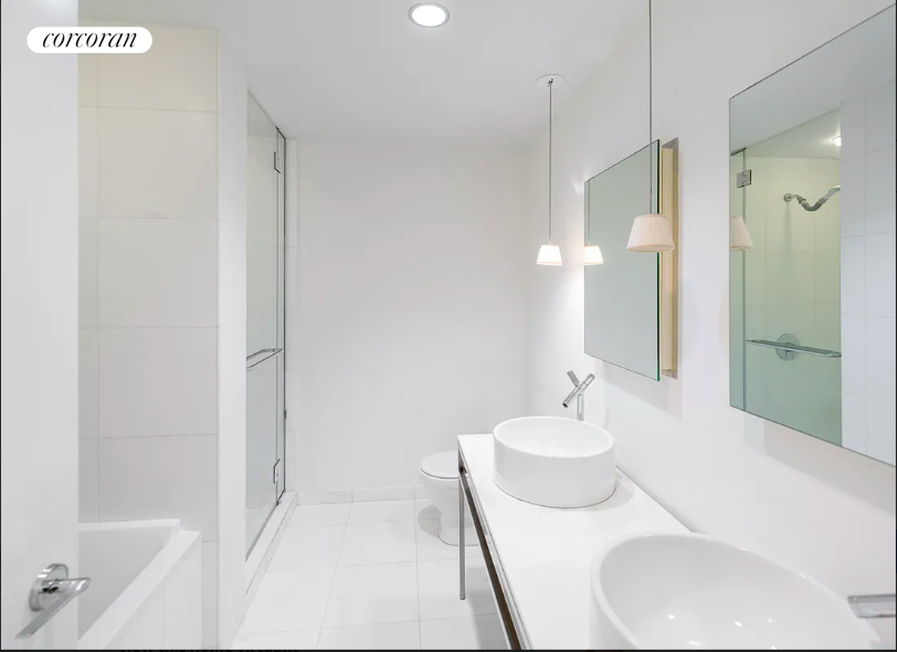 15 Broad Street, Unit 1610 Manhattan, NY 10005 - Photo 5 of 8 a bathroom with a sink a toilet and shower