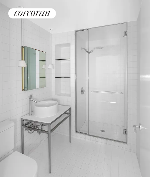 15 Broad Street, Unit 1610 Manhattan, NY 10005 - Photo 7 of 8 a bathroom with a granite countertop sink mirror vanity and toilet