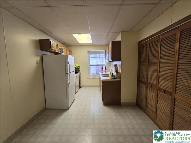 a view of a refrigerator in kitchen and utility room