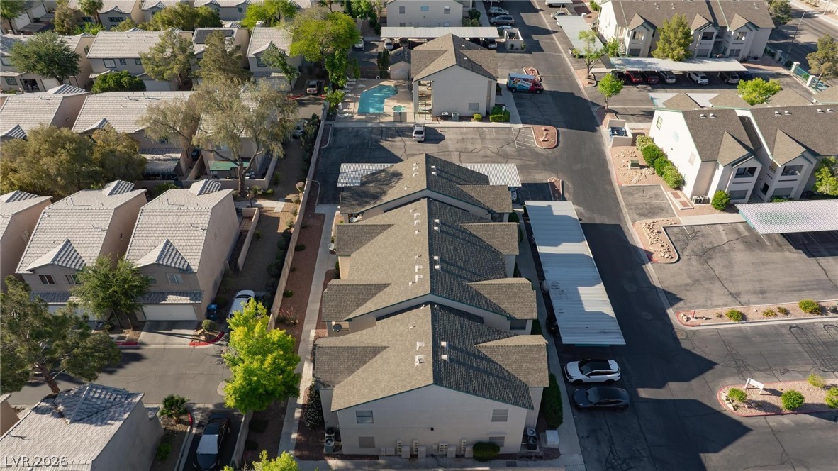 5171 South Lindell Road, Unit 103 Las Vegas, NV 89118 - Photo 23 of 24 An aerial perspective reveals the well-planned layout of a residential community with ample parking and a refreshing pool.
