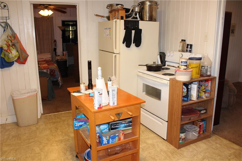4758 Kinnamon Road Clemmons, NC 27012 - Photo 8 of 30 Kitchen has stove, refrigerator and eat in area for kitchen table & chairs