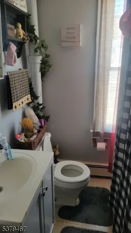 a bathroom with a sink toilet and window