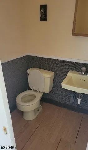 a white toilet sitting next to a bathroom sink