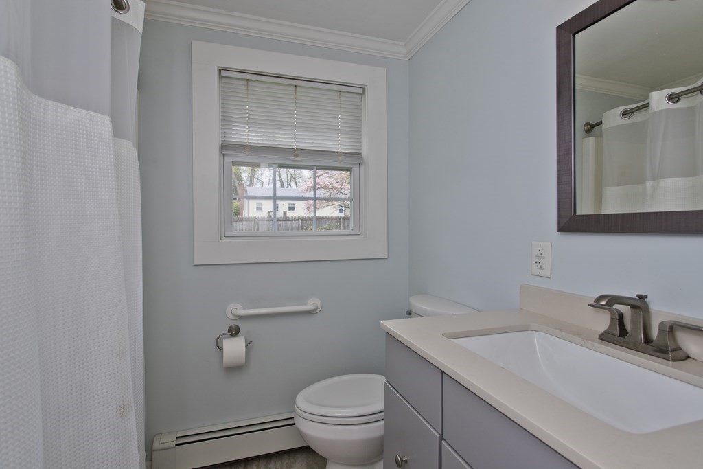 30 Endecott Street Springfield, MA 01118 - Photo 21 of 40 a bathroom with a granite countertop toilet a sink a mirror and a window