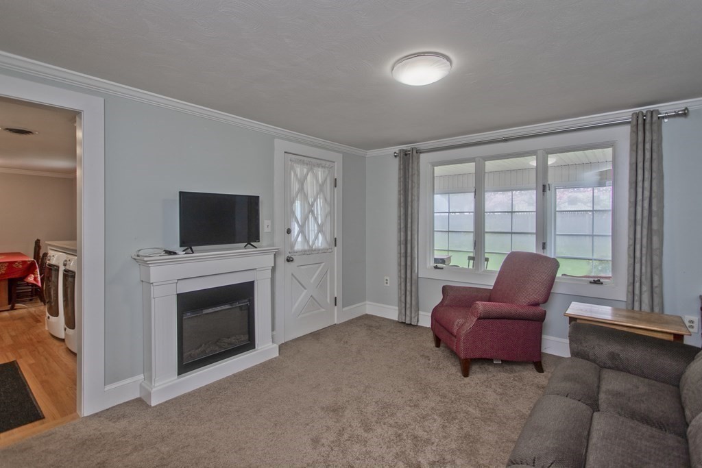 30 Endecott Street Springfield, MA 01118 - Photo 26 of 40 a living room with furniture a flat screen tv and a fireplace