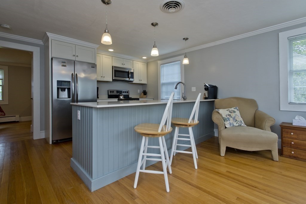 30 Endecott Street Springfield, MA 01118 - Photo 9 of 40 a view of kitchen with cabinets and wooden floor