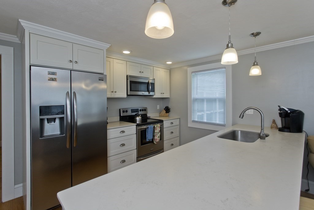 30 Endecott Street Springfield, MA 01118 - Photo 10 of 40 a kitchen with stainless steel appliances a refrigerator sink and microwave
