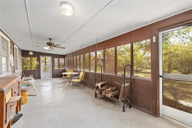 a living room with furniture and large windows