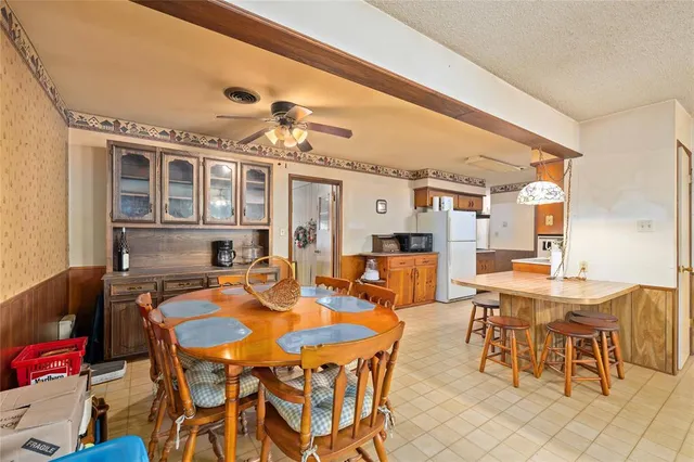 a view of a dining room with furniture and chandelier