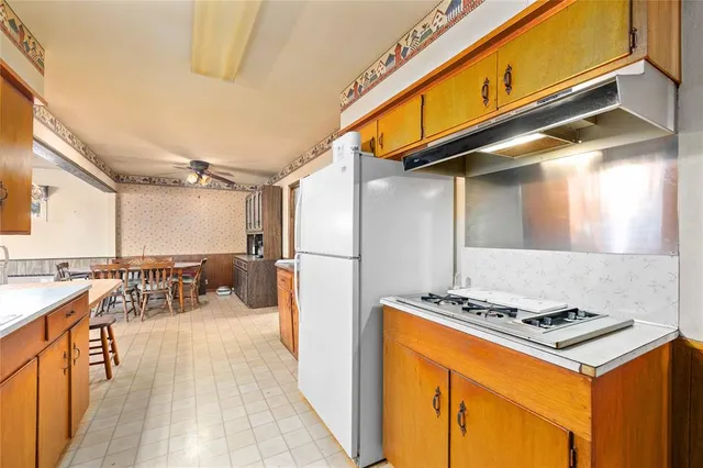 a view of a kitchen with a stove and a refrigerator