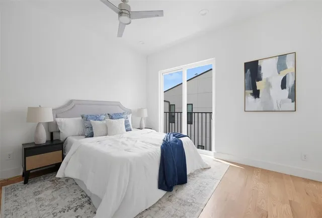 a bedroom with a large bed and a painting on the wall