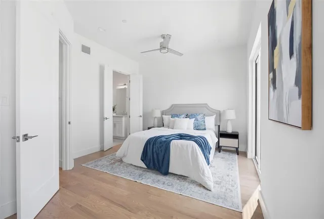 a bedroom with a bed and a painting