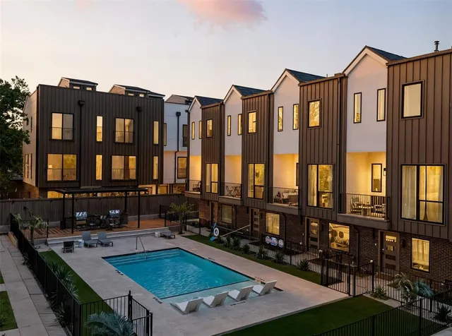 a view of a house with pool and chairs