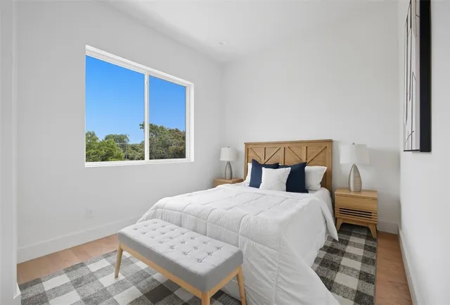 a bedroom with a bed and a window