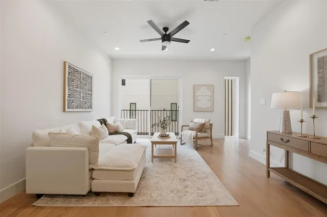 a living room with furniture and wooden floor