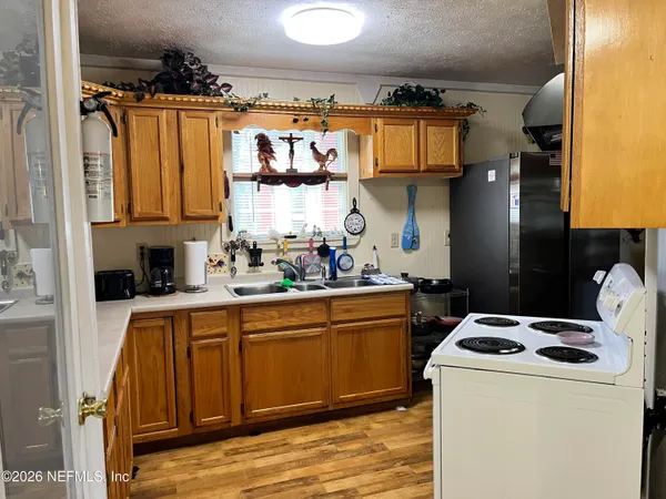 a kitchen with stainless steel appliances granite countertop a sink and cabinets