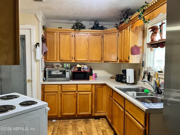 a kitchen with stainless steel appliances a stove a sink and a refrigerator
