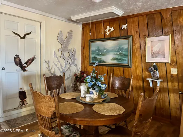 a dining room with furniture and wooden floor