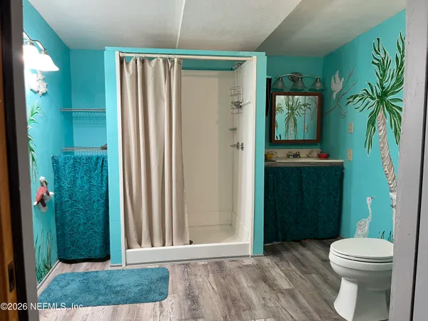 a bathroom with a toilet a sink and shower