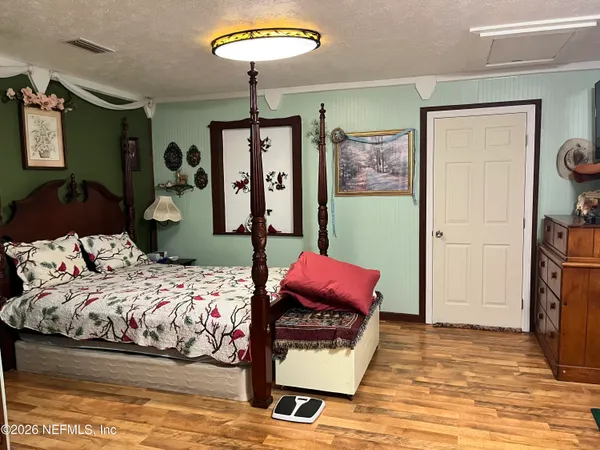 a bedroom with a bed and a chandelier
