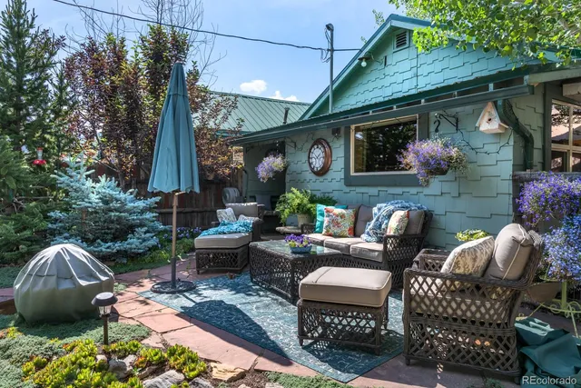 a backyard of a house with outdoor seating