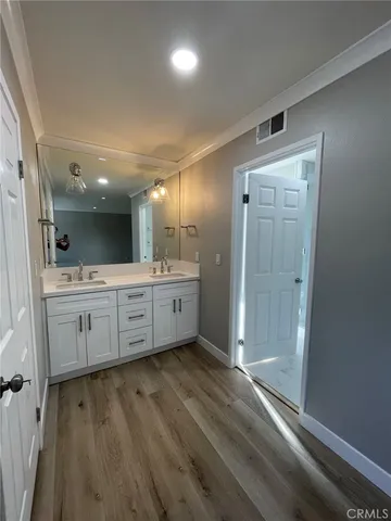 a bathroom with a double vanity sink mirror and shower