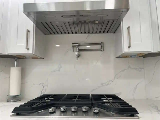 a close view of a stove a microwave and cabinets