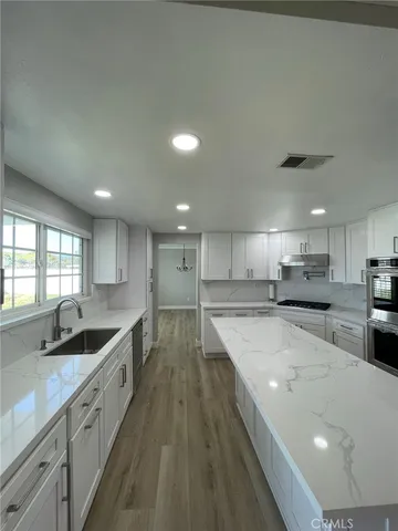 a kitchen with stainless steel appliances granite countertop a sink counter space and cabinets