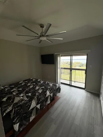 a bed sitting in a spacious bedroom next to a window