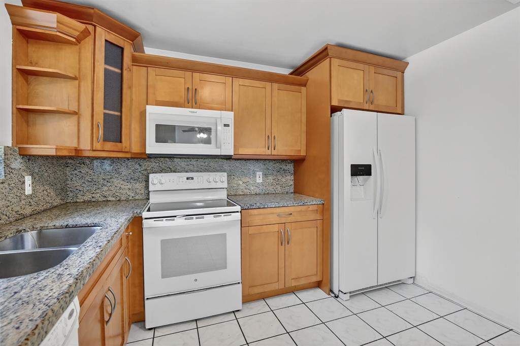 4631 Southwest 54th Terrace Davie, FL 33314 - Photo 13 of 42 a kitchen with cabinets and window