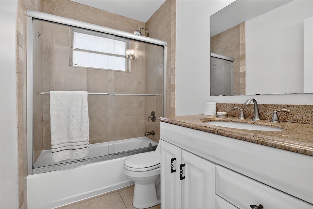 4631 Southwest 54th Terrace Davie, FL 33314 - Photo 26 of 42 a bathroom with a granite countertop sink toilet and shower