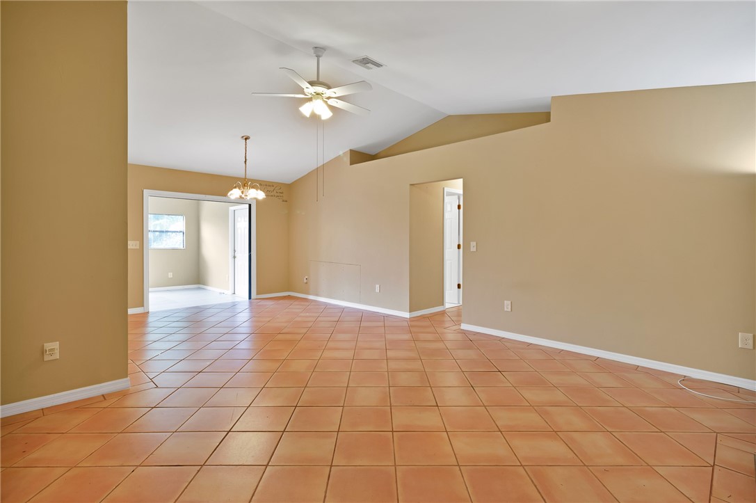 1055 Barber Street Sebastian, FL 32958 - Photo 15 of 18 a view of an empty room with a chandelier fan
