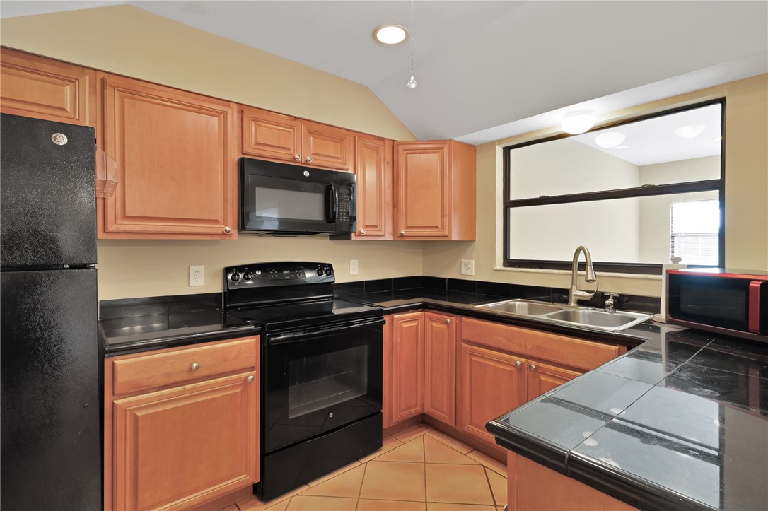 1055 Barber Street Sebastian, FL 32958 - Photo 17 of 18 a kitchen with a sink stove top oven and microwave