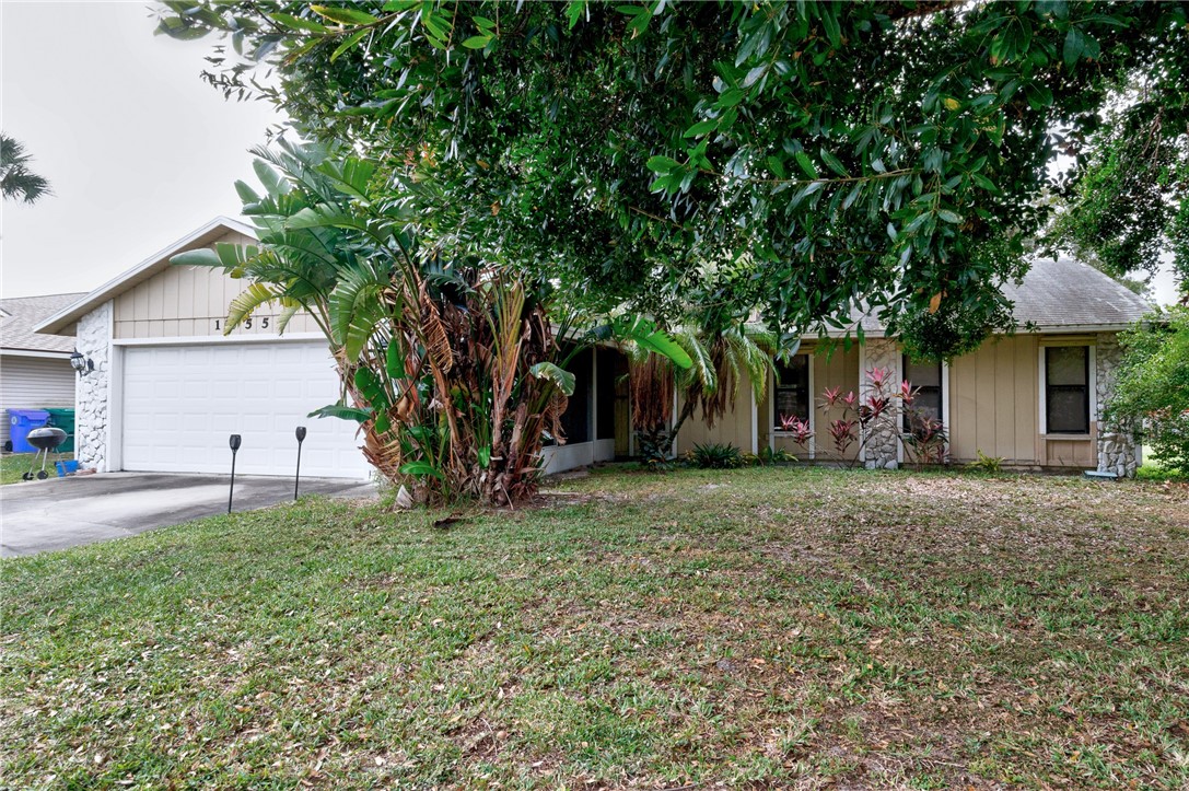 1055 Barber Street Sebastian, FL 32958 - Photo 2 of 18 a view of a house with a yard and large tree