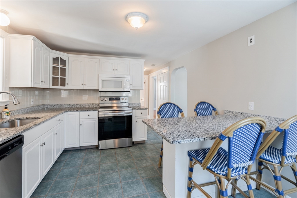 9 Pearl Street Walpole, MA 02081 - Photo 3 of 22 a kitchen with stainless steel appliances granite countertop a white cabinets